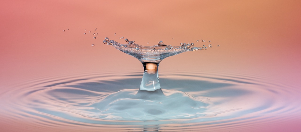 water droplet splashing into a pond