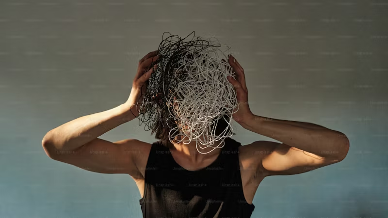 man with a mess of wiring in front of his face