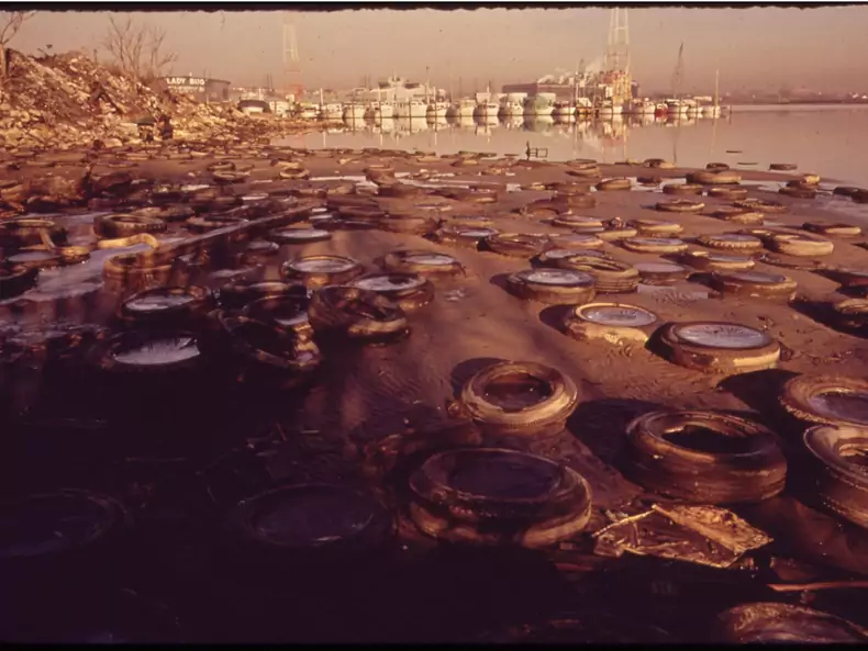 Trash and old tires on the shore of Baltimore Harbor. 