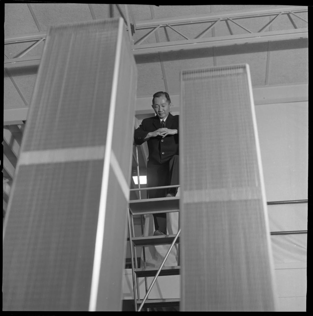 Yamasaki standing over models of the World Trade Centers.