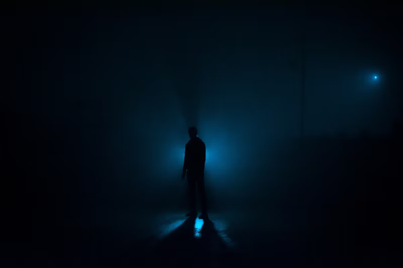 Silhouette with a blue light behiind