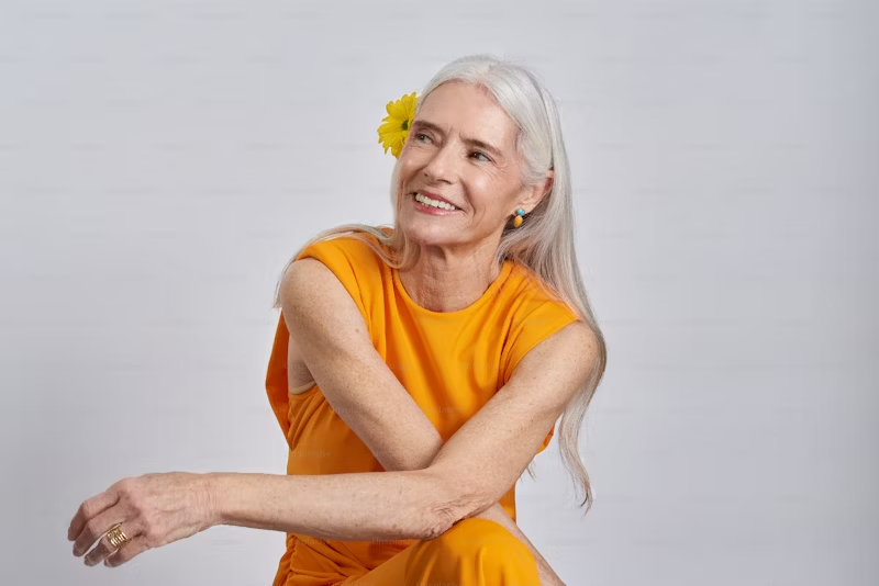 Older woman in an orange dress