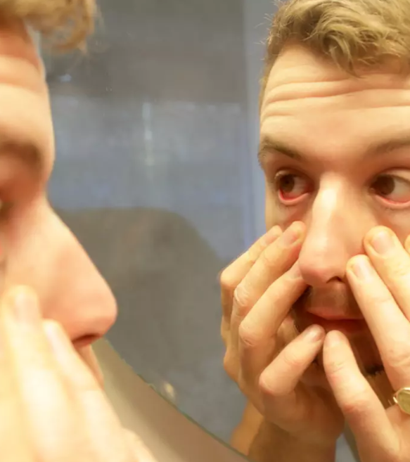 person looking at own eye