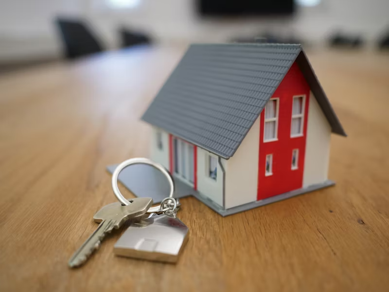 set of keys beside a tiny house