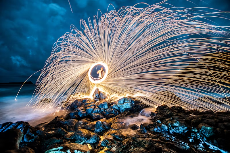 person spinning a sparkler around very quickly