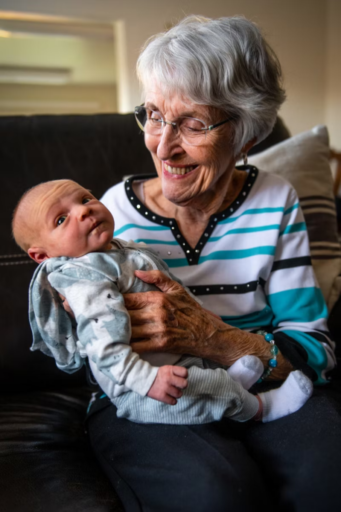 older woman with a very young baby