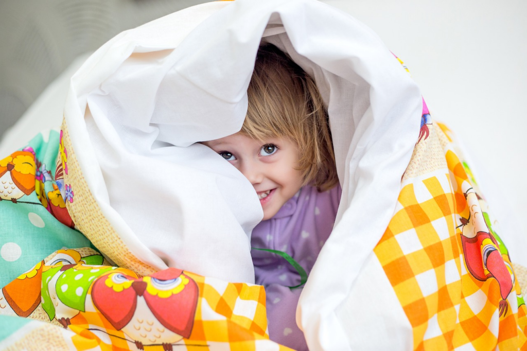 little girl waiting to surprise someone