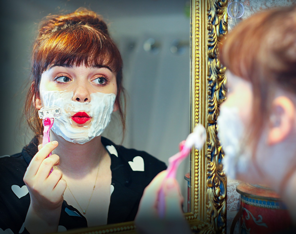woman shaving face