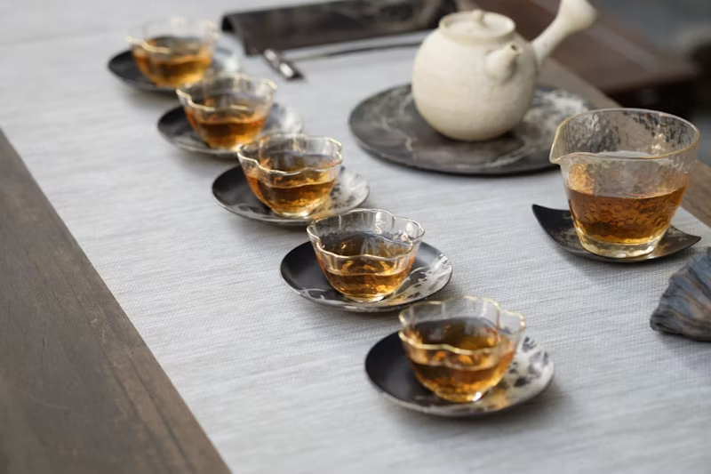 multiple smaller cups of tea lined up for consumption
