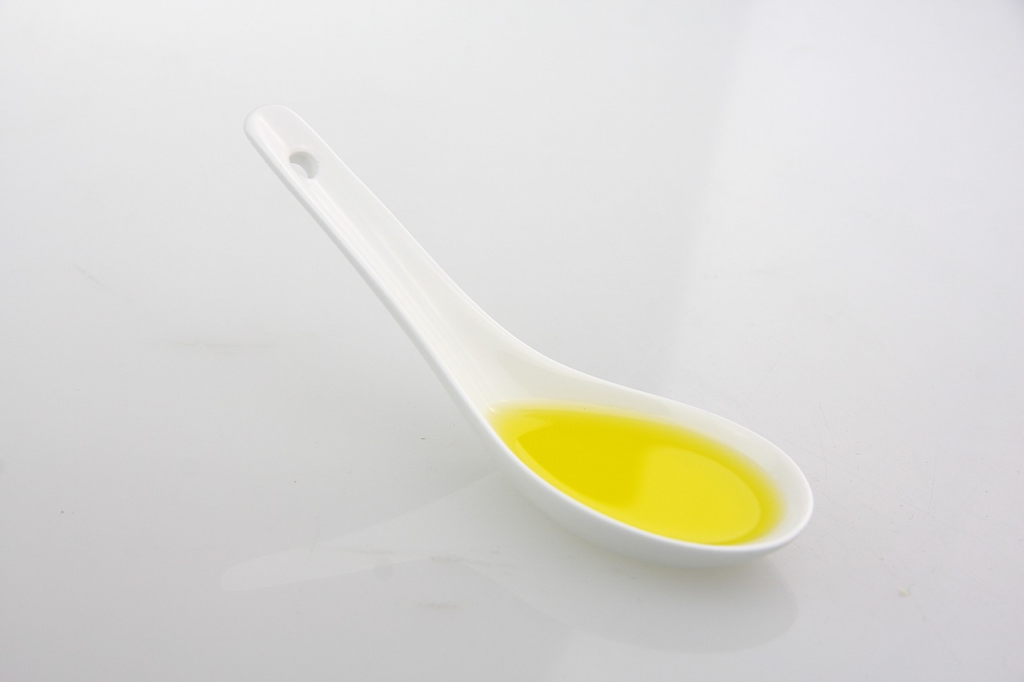 Olive oil in a porcelain spoon