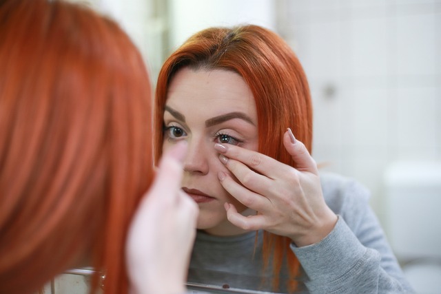 woman taking out contact lenses