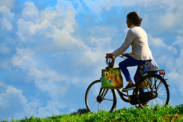 healthy middle age woman riding bike