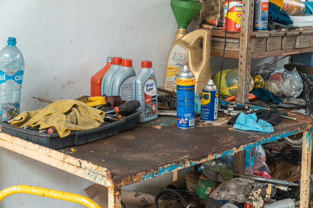 tool bench / work bench with paint supplies, motor oil, and WD-40 on it