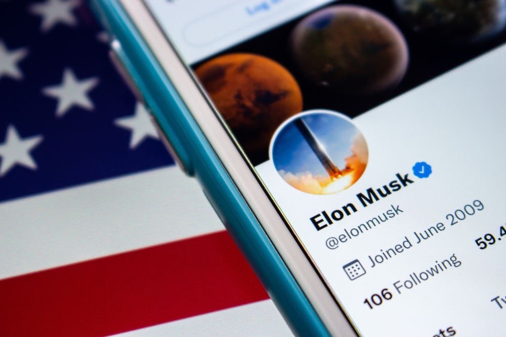 Kumamoto, JAPAN - Aug 26 2021 : Elon Musk twitter account on iPhone on the US flag. He is known as founder, CEO, and Chief Engineer at aerospace manufacturer, space transportation corporation SpaceX