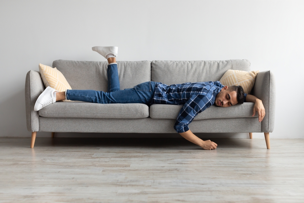 Lack of Energy Concept. Full Body Length Of Exhausted Sleepless Young Man Lying On The Couch With Face Down, Tired In The End Of Hard Working Day, Fatigued Middle Eastern Male Resting At Home