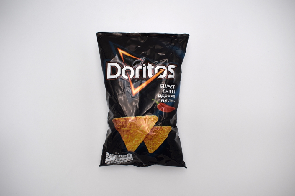 Kongsvinger, Norway 30 october 2022: Doritos Sweet Chilli Pepper flavour Tortilla Chips flavor package savory crisps snacks food isolated on white background