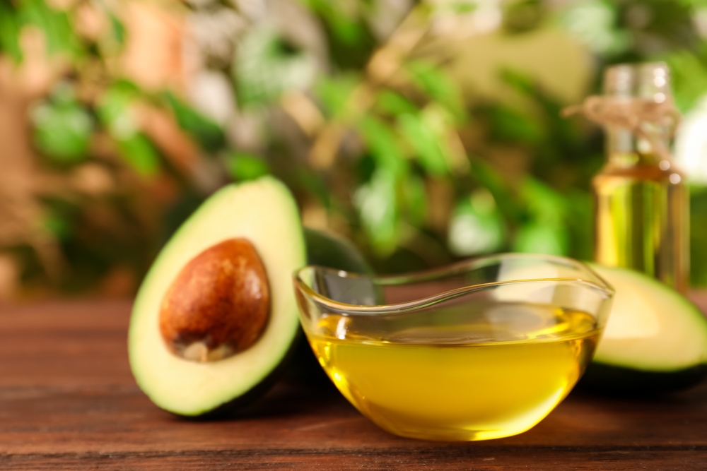 Avocado oil, raw healthy organic avocado oil with avocado fruits