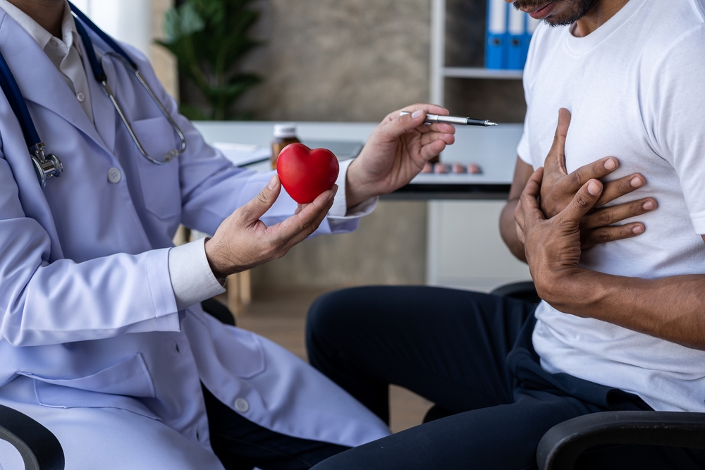 Male doctor caring for patient holding stethoscope listening to patient during home visit Doctor examining heartbeat examining man with heart disease, heart disease concept