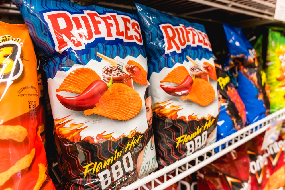 Miami, Florida, USA - Aug 03, 2023: Ruffles Flamin Hot BBQ crinkle-cut potato chips for sale at a supermarket.