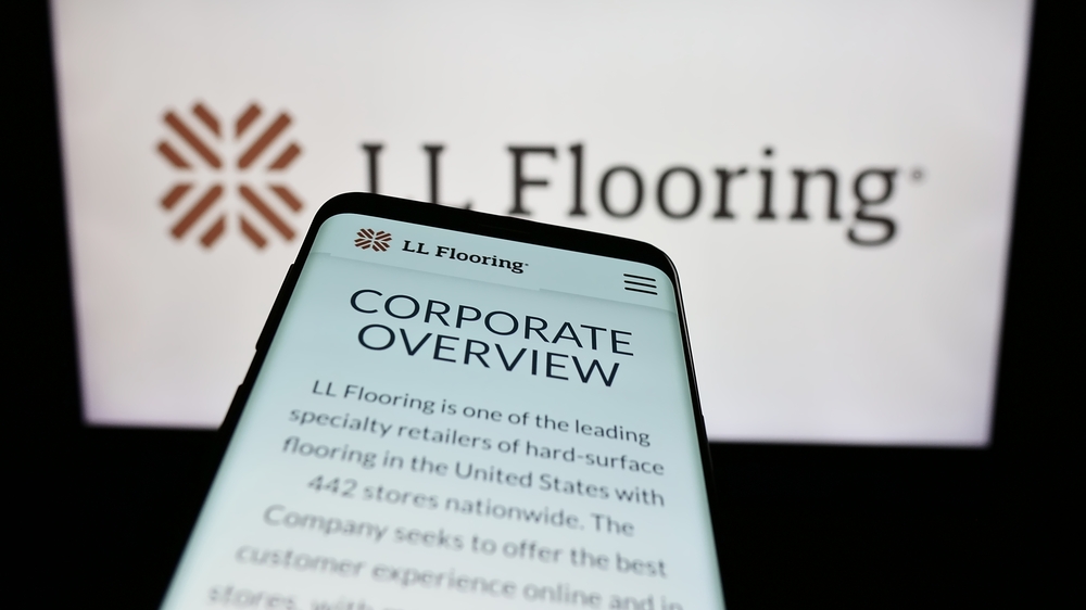 Stuttgart, Germany - 10-28-2023: Mobile phone with webpage of US retail company LL Flooring in front of business logo. Focus on top-left of phone display. Unmodified photo.