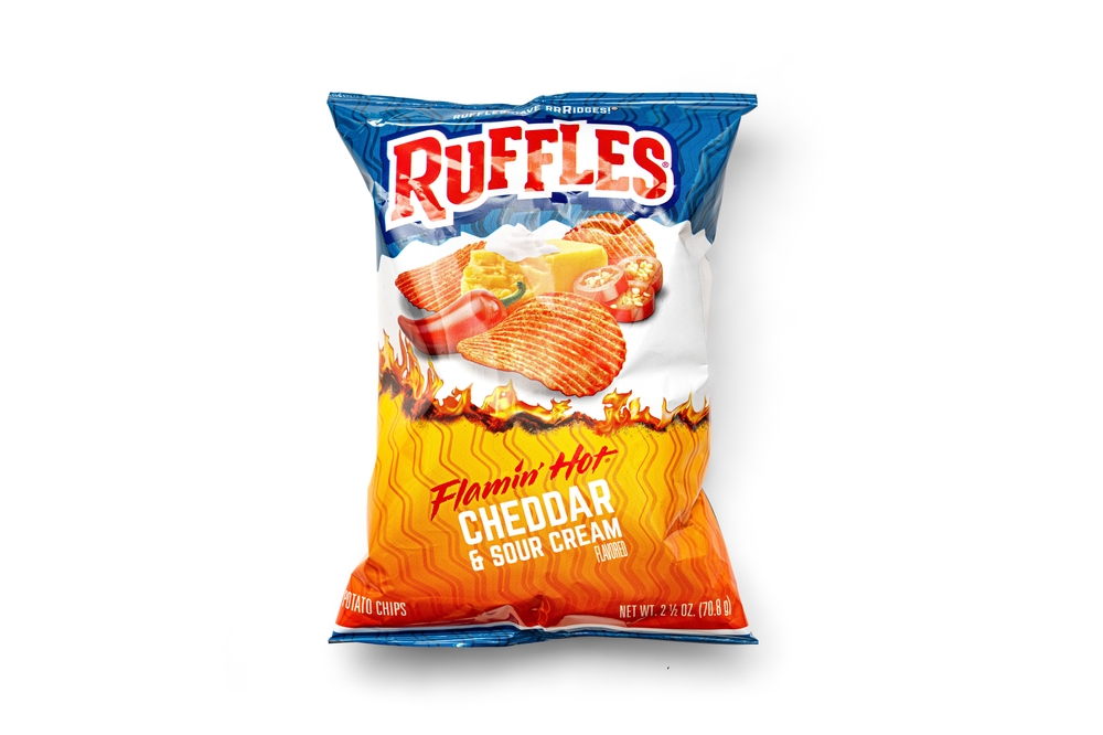 Duluth, Ga United States 04.17.2024 Ruffles Flamin' Hot Cheddar and Sour Cream Potato Chips - Bold Flavor, Crunchy Texture Isolated on white background