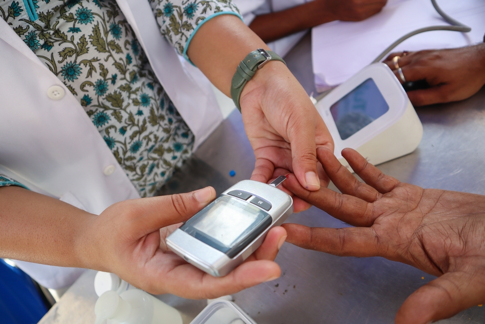Mysuru, Karnataka, India-April 21 2024; An Endocrinologist is examining the Blood Sugar levels of a patient using a Glucometer at a Diabetes care Hospital in Mysore, India.