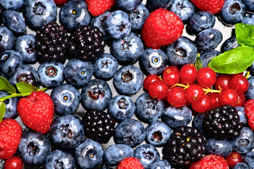 Mix of different berry berries. Berries fruits background. Antioxidants, detox diet, organic berries. Wild berries pattern. Berry background.