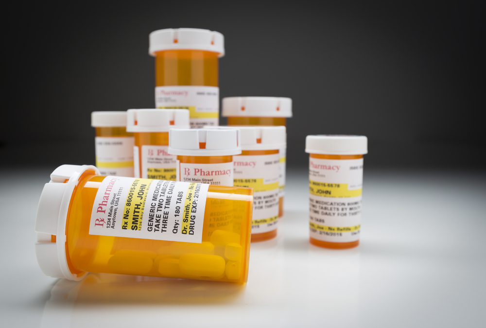 Variety of Non-Proprietary Medicine Bottles on Reflective Surface and Grey Background.
Photo Formats