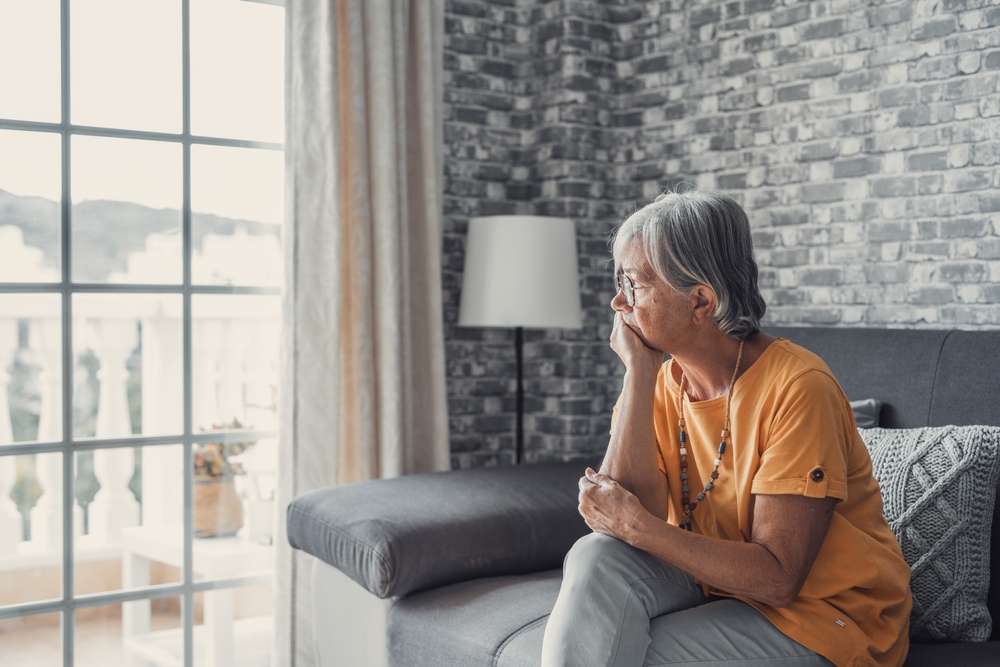 Face of senior caucasian hoary woman looking away deep in sad thoughts feels lonely close up portrait, recollect memories and life moments, depressed grandmother alone indoors, yearning for husband