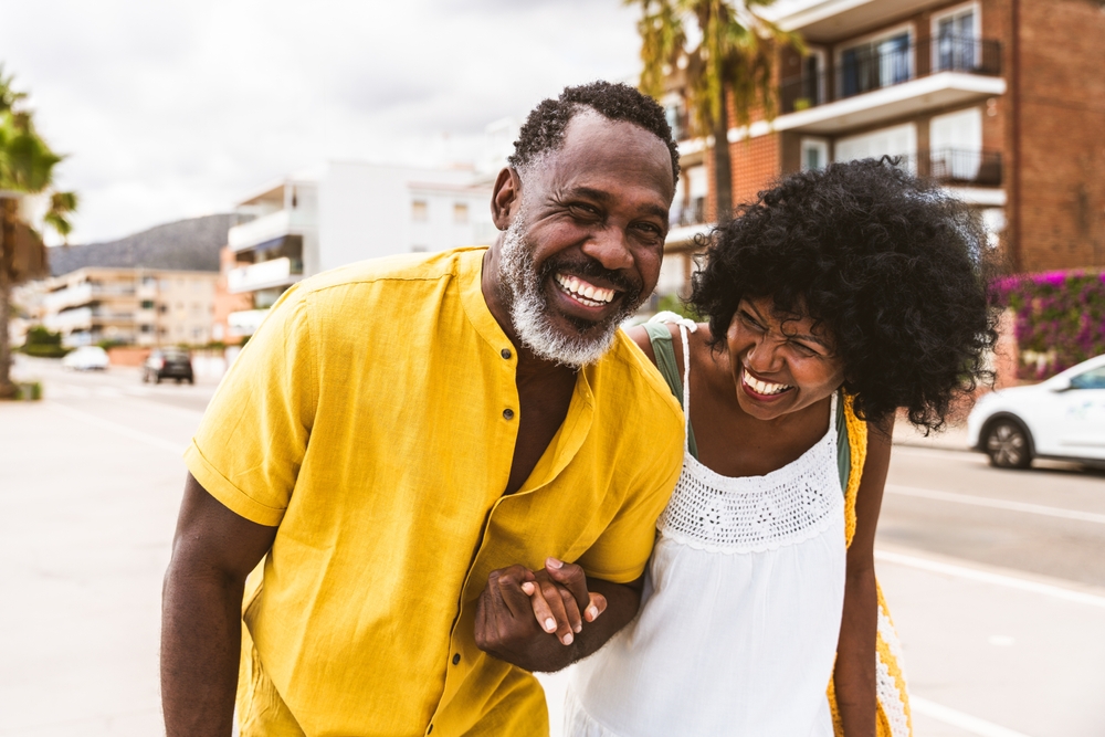 Beautiful mature black couple of lovers dating at the seaside - Married african middle-aged couple bonding and having fun outdoors, concepts about relationship, lifestyle and quality of life