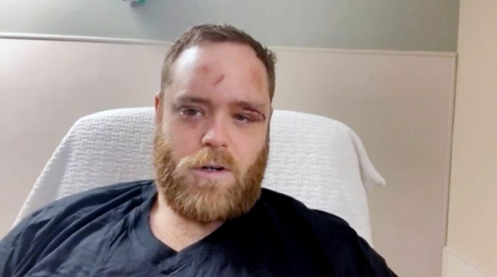 A man sitting in a hospital bed. 