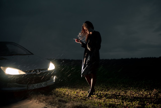 woman in the rain with her car 