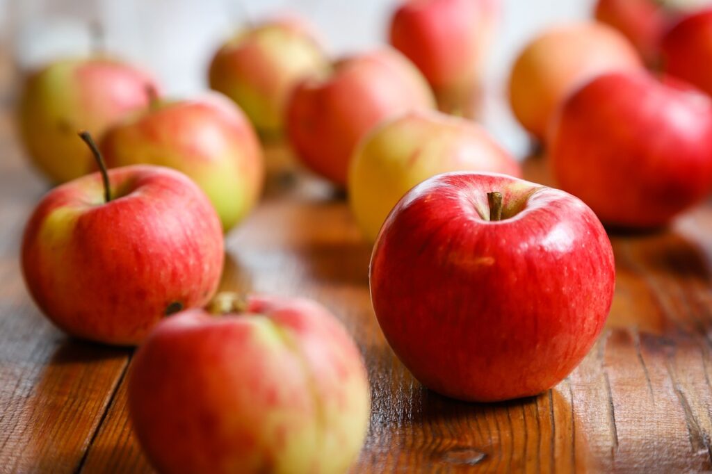 Red apples. Wooden background.