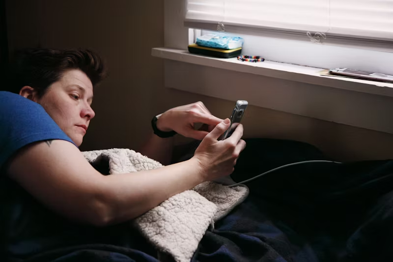 woman on phone in bed
