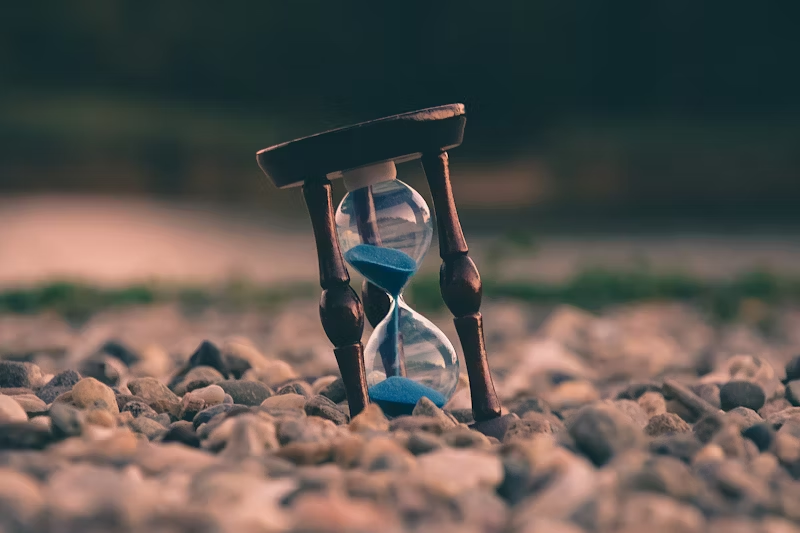 An hourglass on some rocks