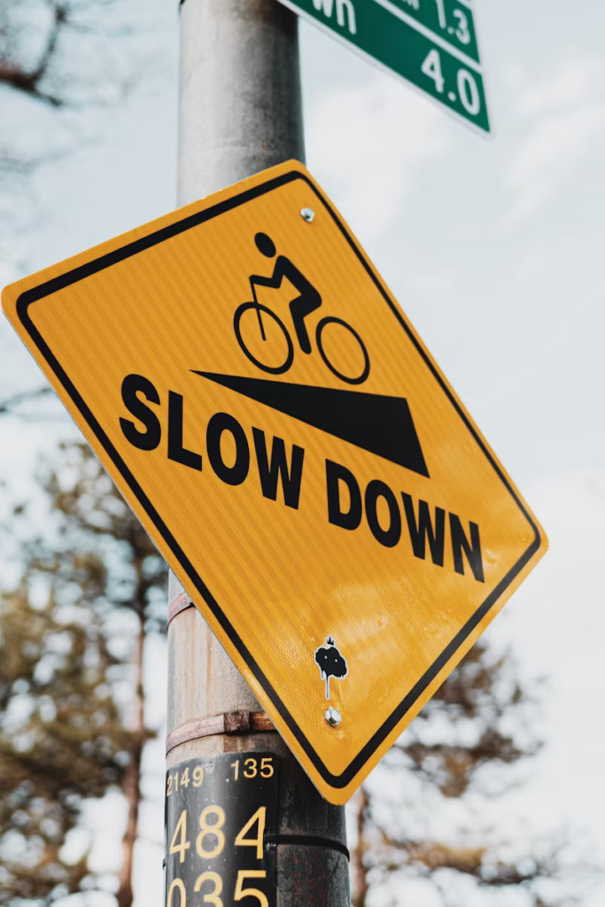 A road sign saying SLOW DOWN