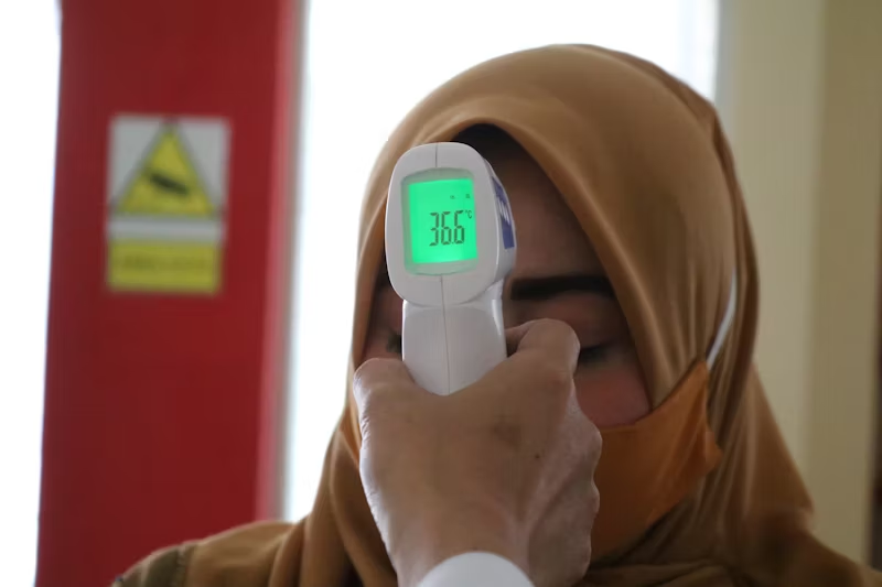 person being checked for body temperature