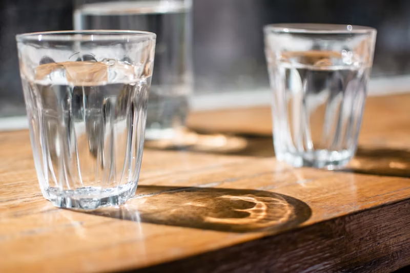glasses of water on a wooden table