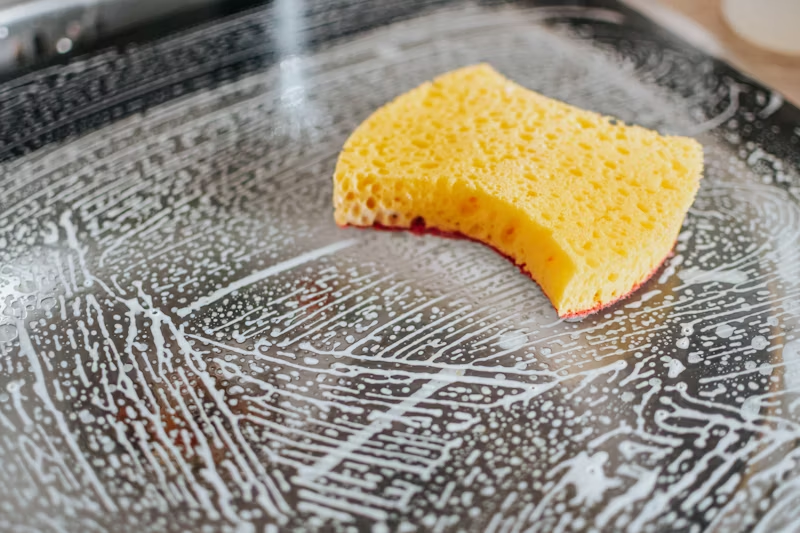 a sponge being used to clean