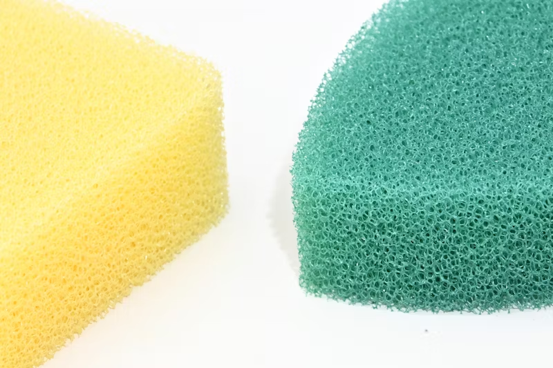 a yellow and a teal sponge
