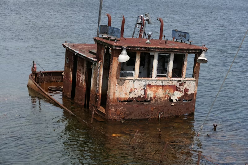 rusted boat in a body of water