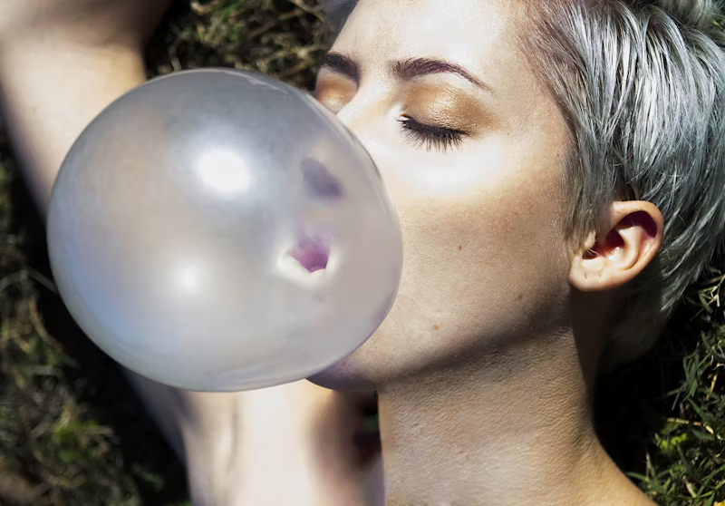 woman blowing a gum bubble