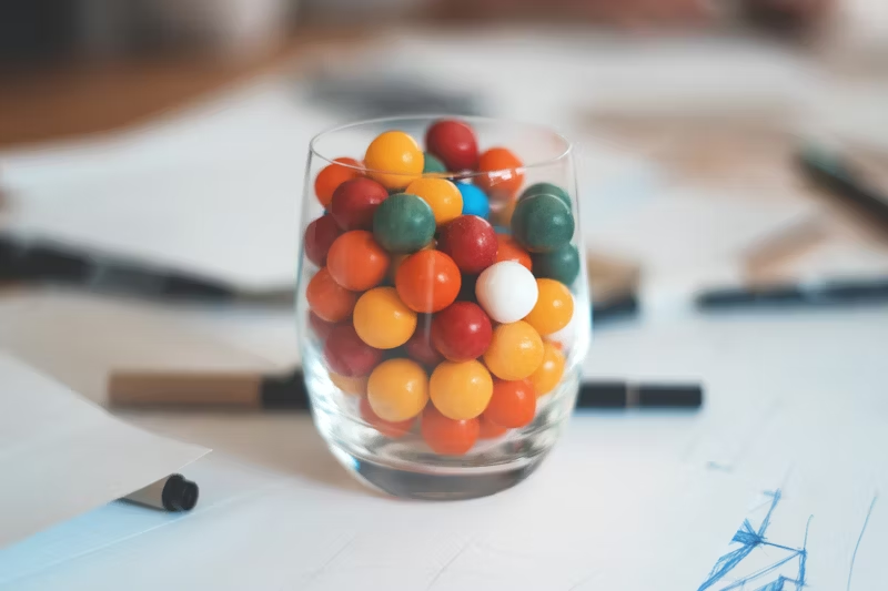 water glass full of gumballs