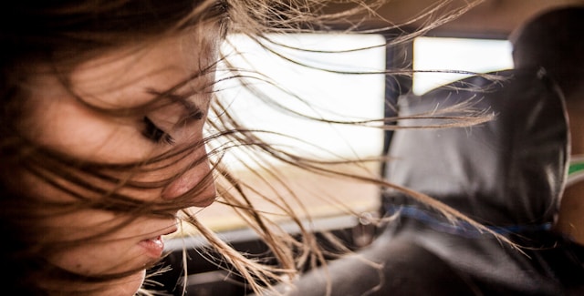 woman wind blowing hair side profile