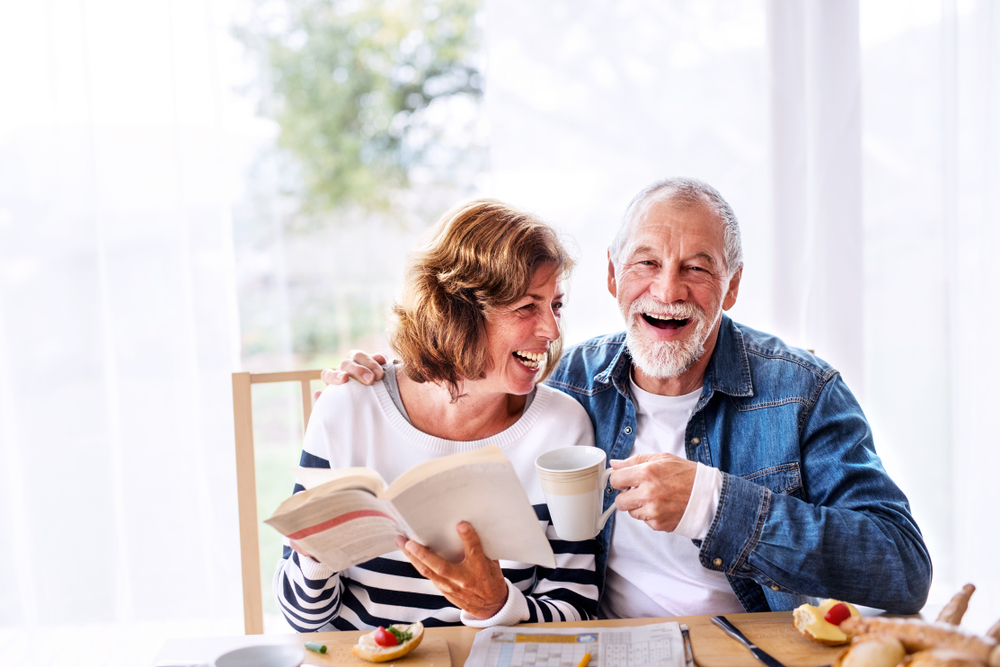Senior couple eating breakfast at home.
