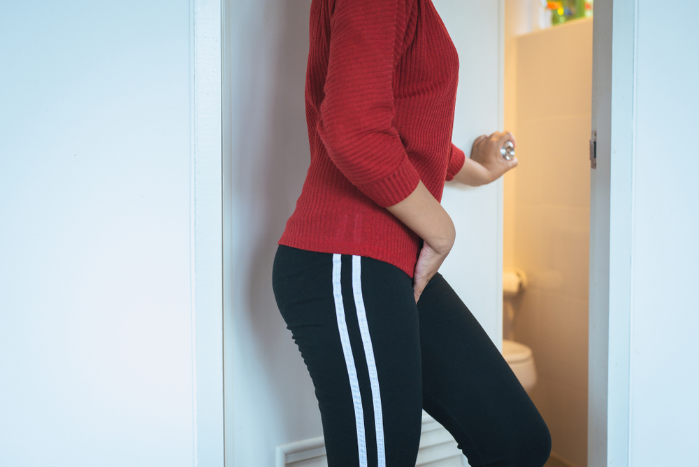 Hands woman holding her crotch,Female need to pee at toilet
