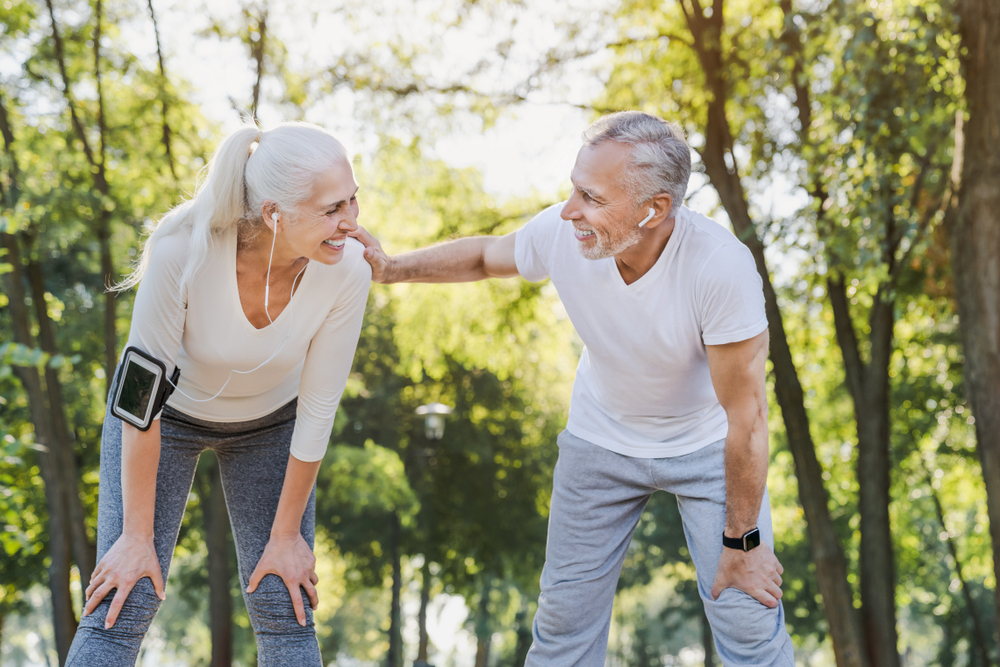 Senior couple resting after workout outdoors
