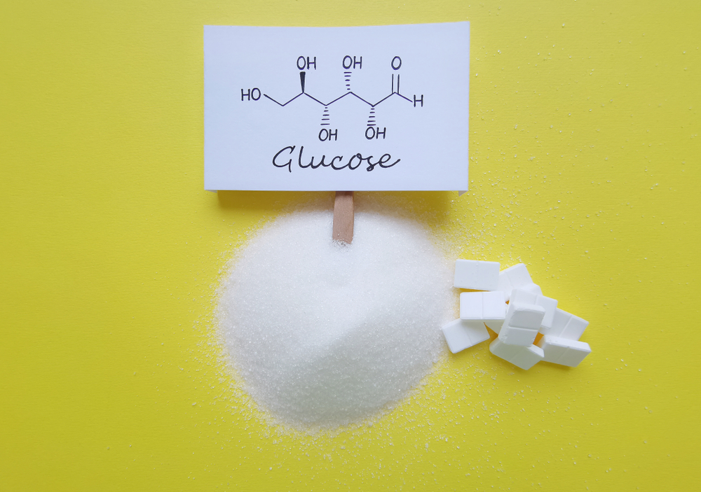 Structural chemical formula of glucose with refined crystalline sugar and cube sugar. D-Glucose (dextrose, blood sugar) is a simple sugar and it is the most abundant monosaccharide.