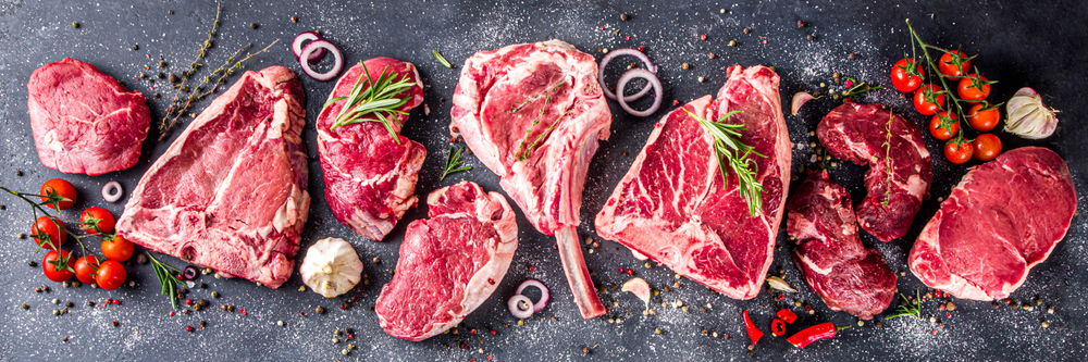 Set of various classic, alternative raw meat, veal beef steaks - chateau mignon, t-bonnet, tomahawk, striploin, tenderloin, tenderloin, new york steak. Flat lay top view on gray stone cutting table
