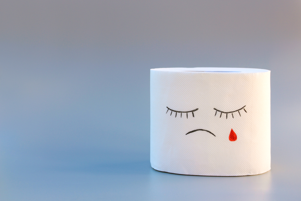 Toilet paper and blood. Concept of hemorrhoid treatment.
